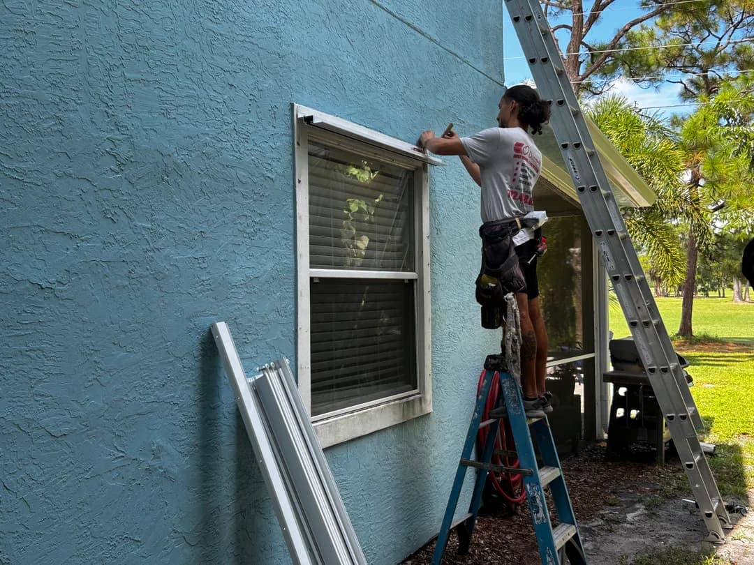 Second-floor accordion shutter installation in Stuart